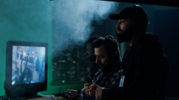 tracking-shot-of-men-and-woman-sitting-at-table-in-dimly-lit-living-room-and-talkin-SBV-346670272-4K.00_00_04_08.Still002-768x432