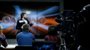 tracking-shot-of-men-and-woman-sitting-at-table-in-dimly-lit-living-room-and-talkin-SBV-346670272-4K.00_00_51_18.Still012-1-768x432